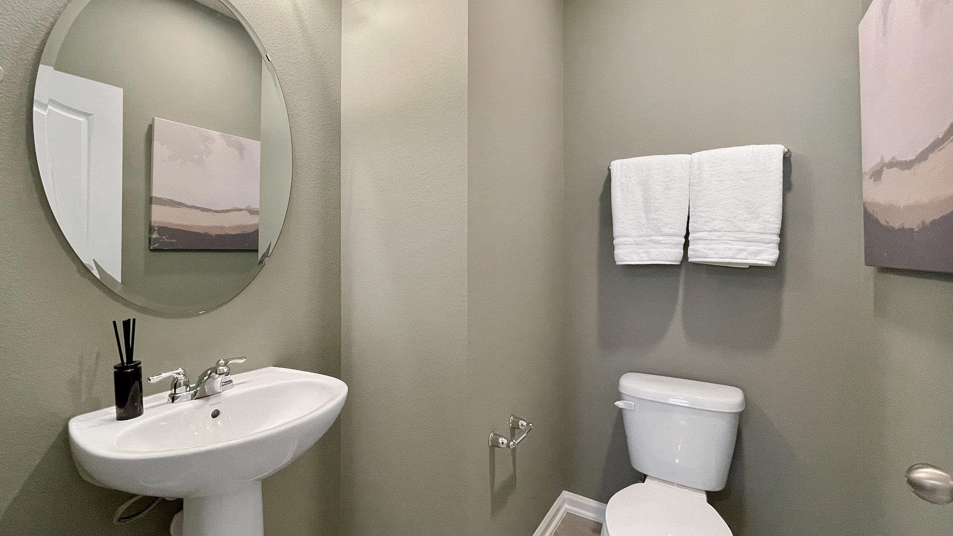 155 Redbud Road Palm Coast, FL 32137 - Photo 27 of 39 a bathroom with a toilet sink and mirror