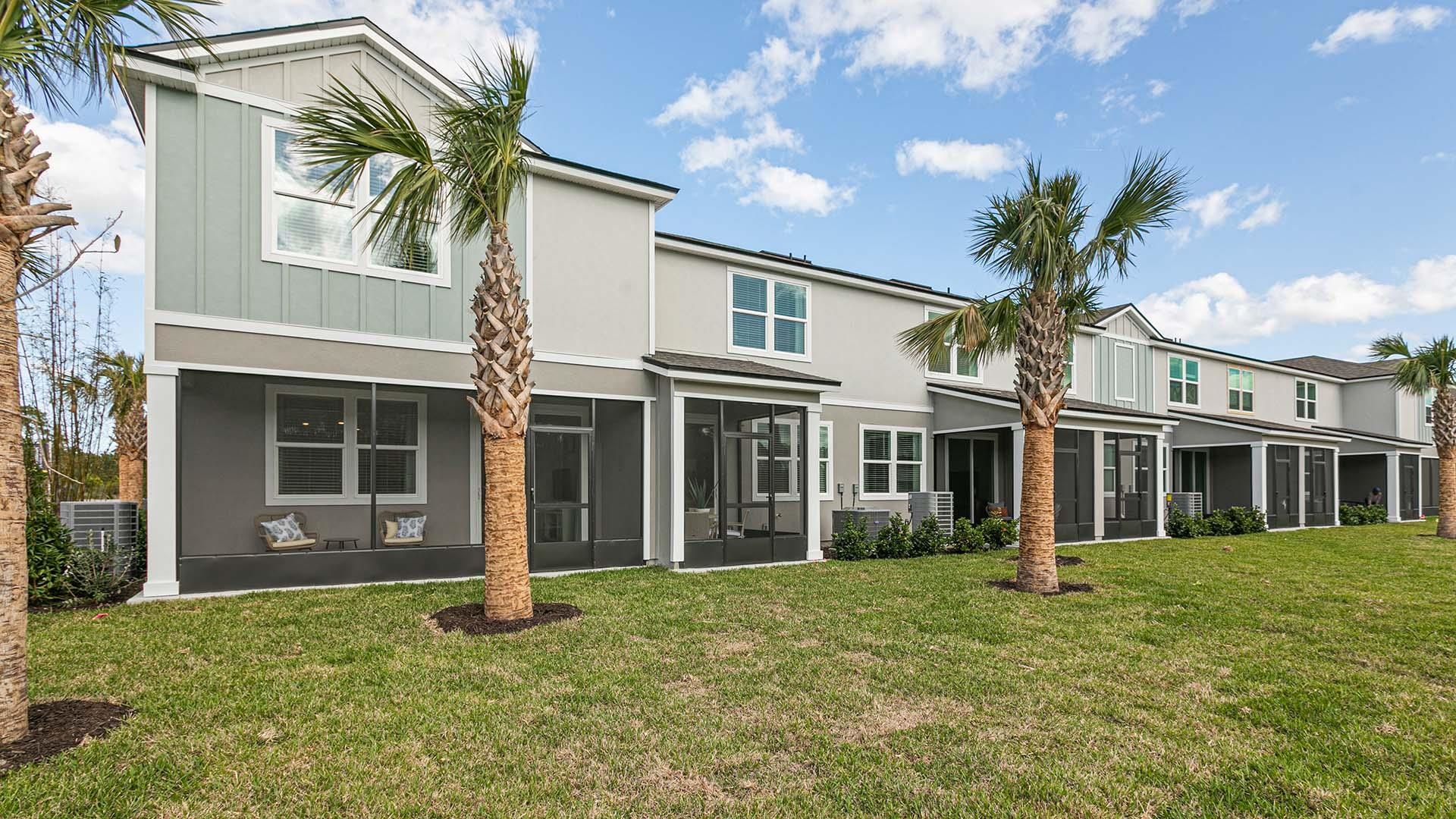 155 Redbud Road Palm Coast, FL 32137 - Photo 29 of 39 a view of a white house with a large window and potted plants