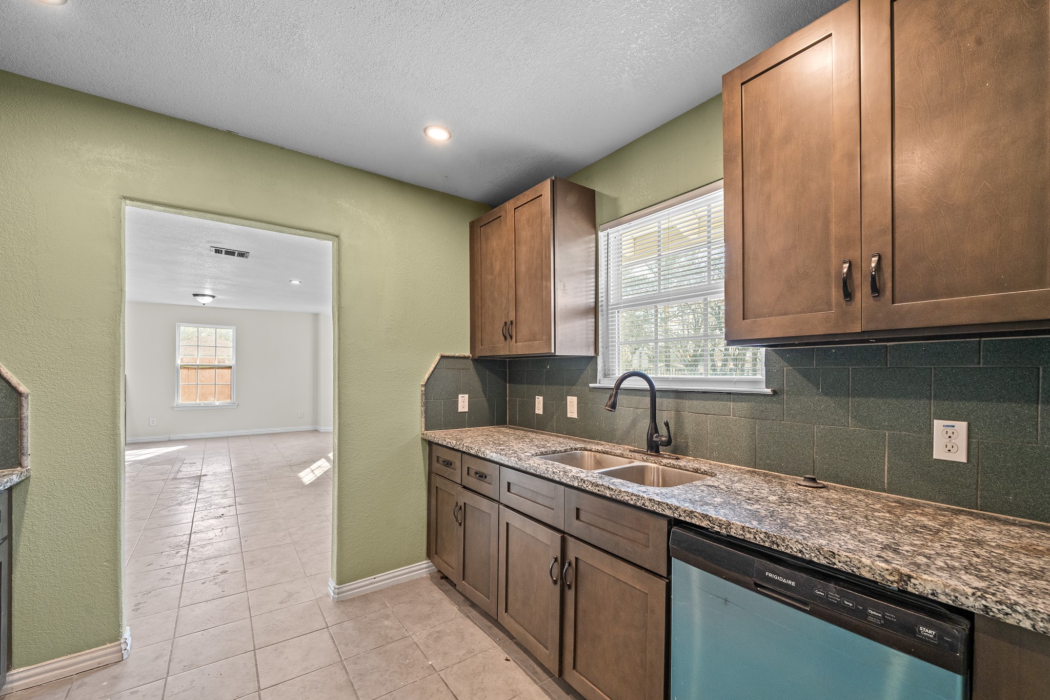 6911 Sherwood Drive Houston, TX 77021 - Photo 9 of 26 a kitchen with stainless steel appliances granite countertop a sink and cabinets