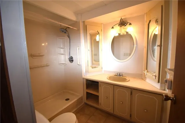 a bathroom with a granite countertop sink mirror and double