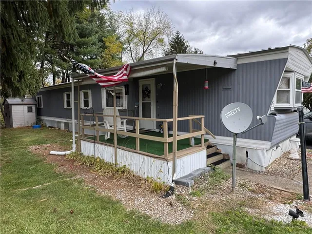 a front view of a house with a yard table and chairs
