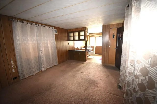 a view of entryway with kitchen and furniture