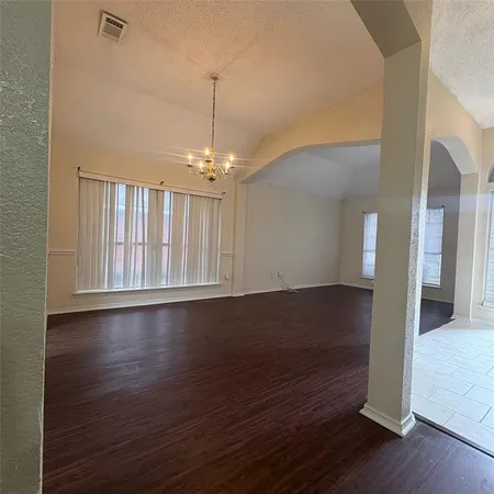 a view of wooden floor and window in a room