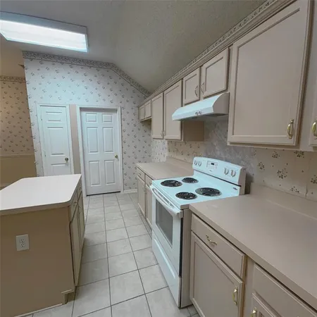 a kitchen with a stove and a refrigerator