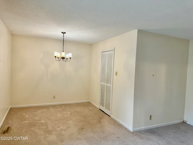 a view of empty room with a fireplace