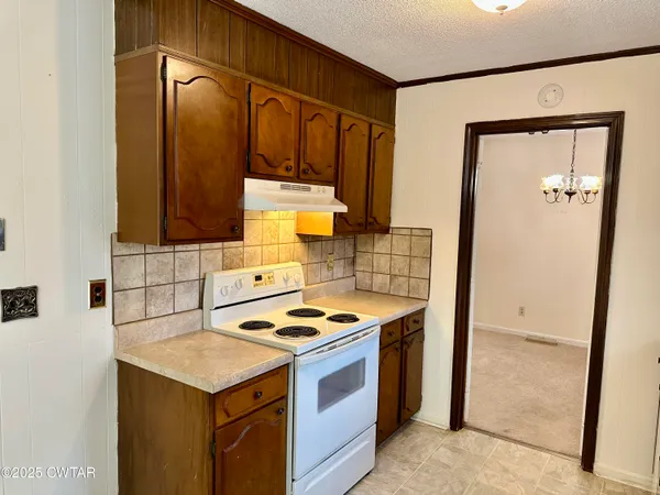 a kitchen with a stove and a refrigerator