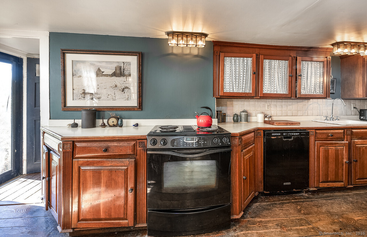 143 Whitcomb Hill Road Cornwall, CT 06754 - Photo 16 of 40 a kitchen with stainless steel appliances granite countertop a stove and a sink