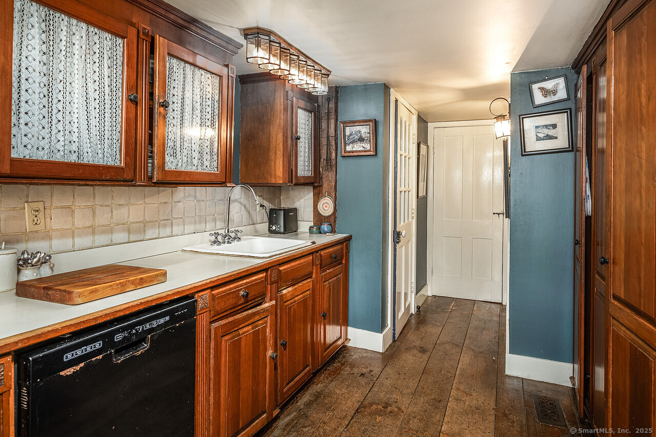 143 Whitcomb Hill Road Cornwall, CT 06754 - Photo 17 of 40 a kitchen with stainless steel appliances granite countertop a sink stove and cabinets