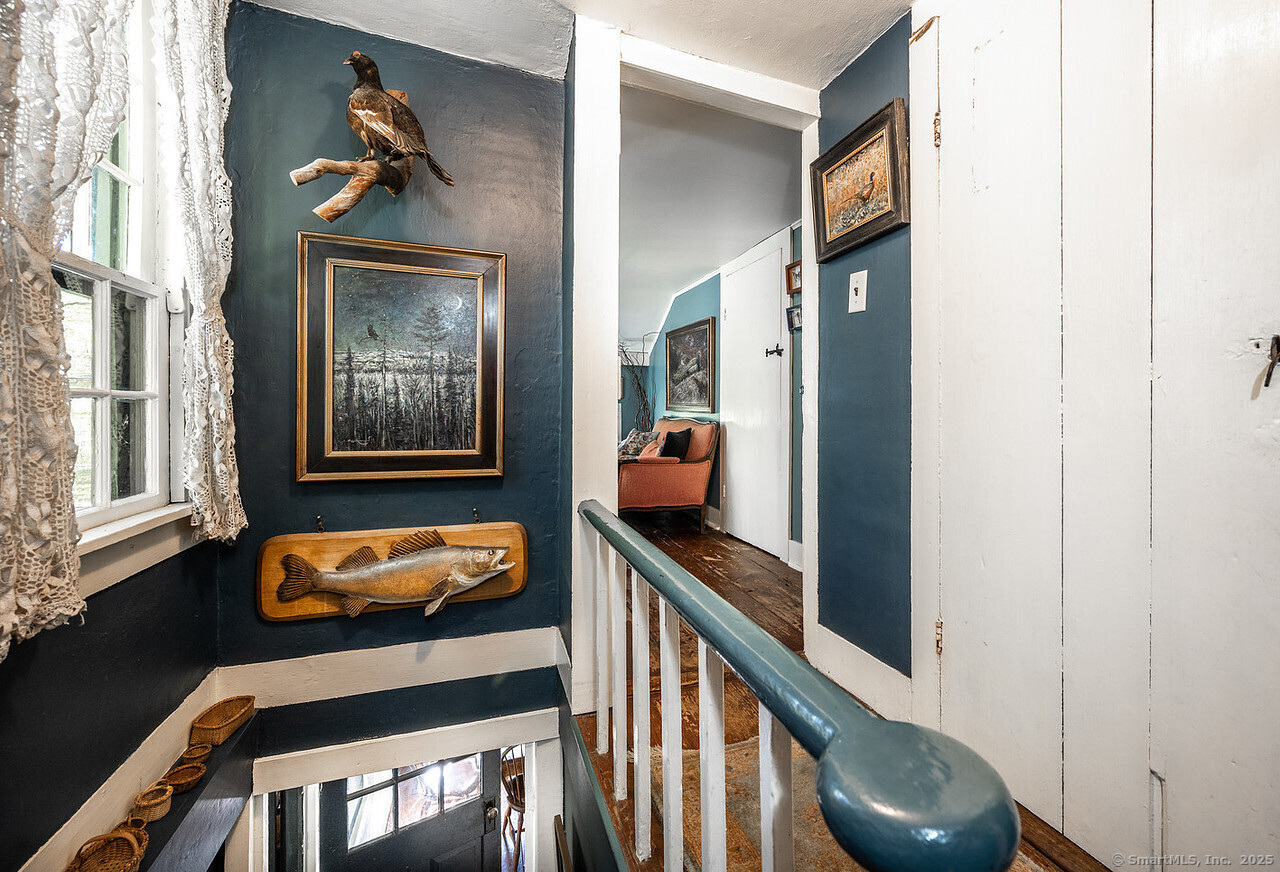 143 Whitcomb Hill Road Cornwall, CT 06754 - Photo 21 of 40 a hallway with with door wooden floor and windows