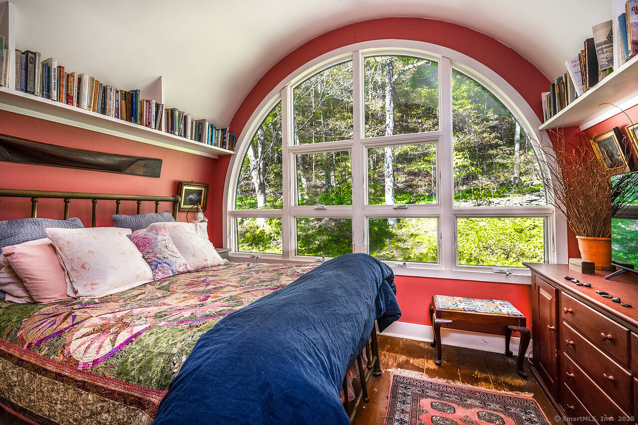 143 Whitcomb Hill Road Cornwall, CT 06754 - Photo 24 of 40 a bedroom with a bed and a large window