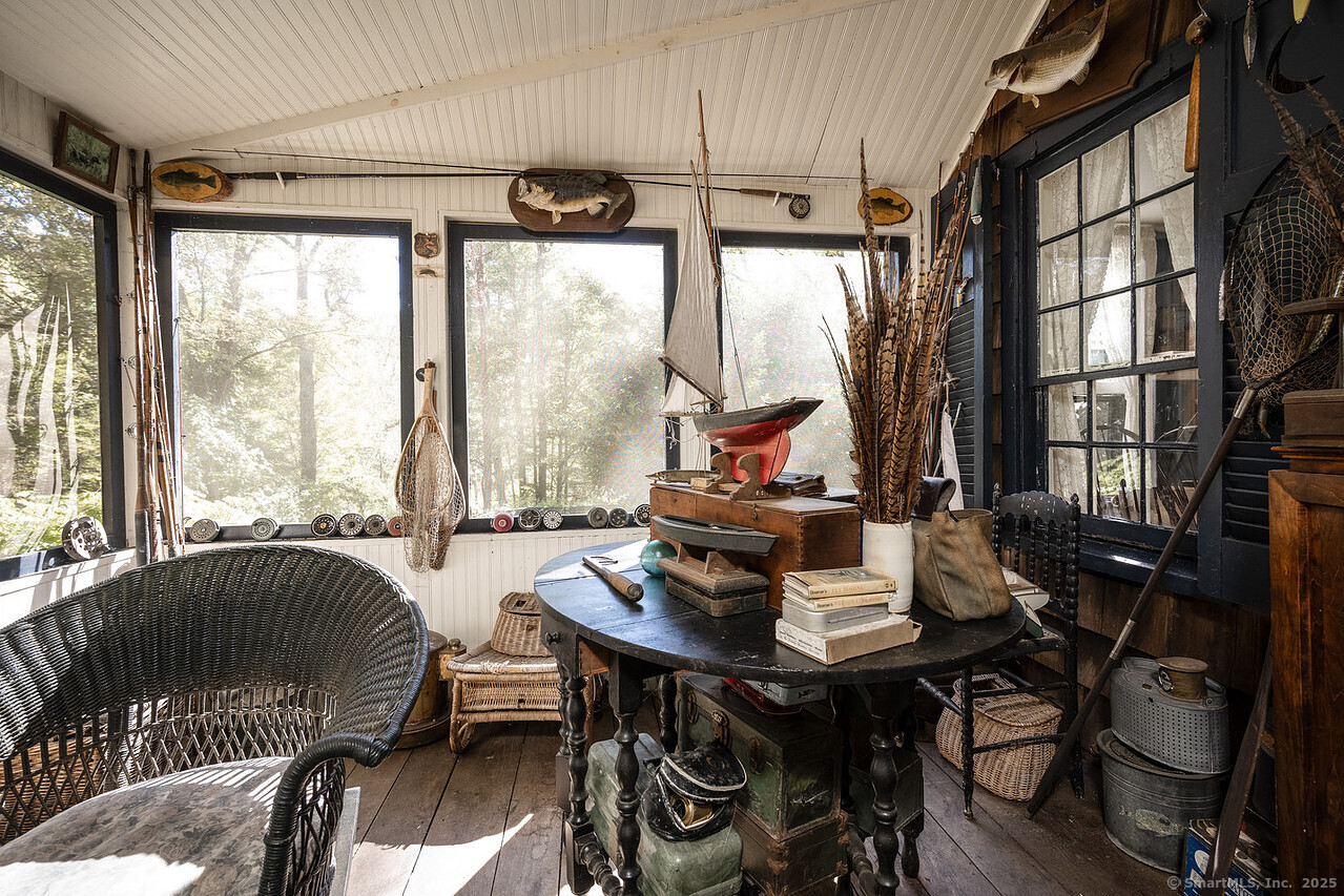 143 Whitcomb Hill Road Cornwall, CT 06754 - Photo 31 of 40 a view of a dining room with furniture large windows and wooden floor