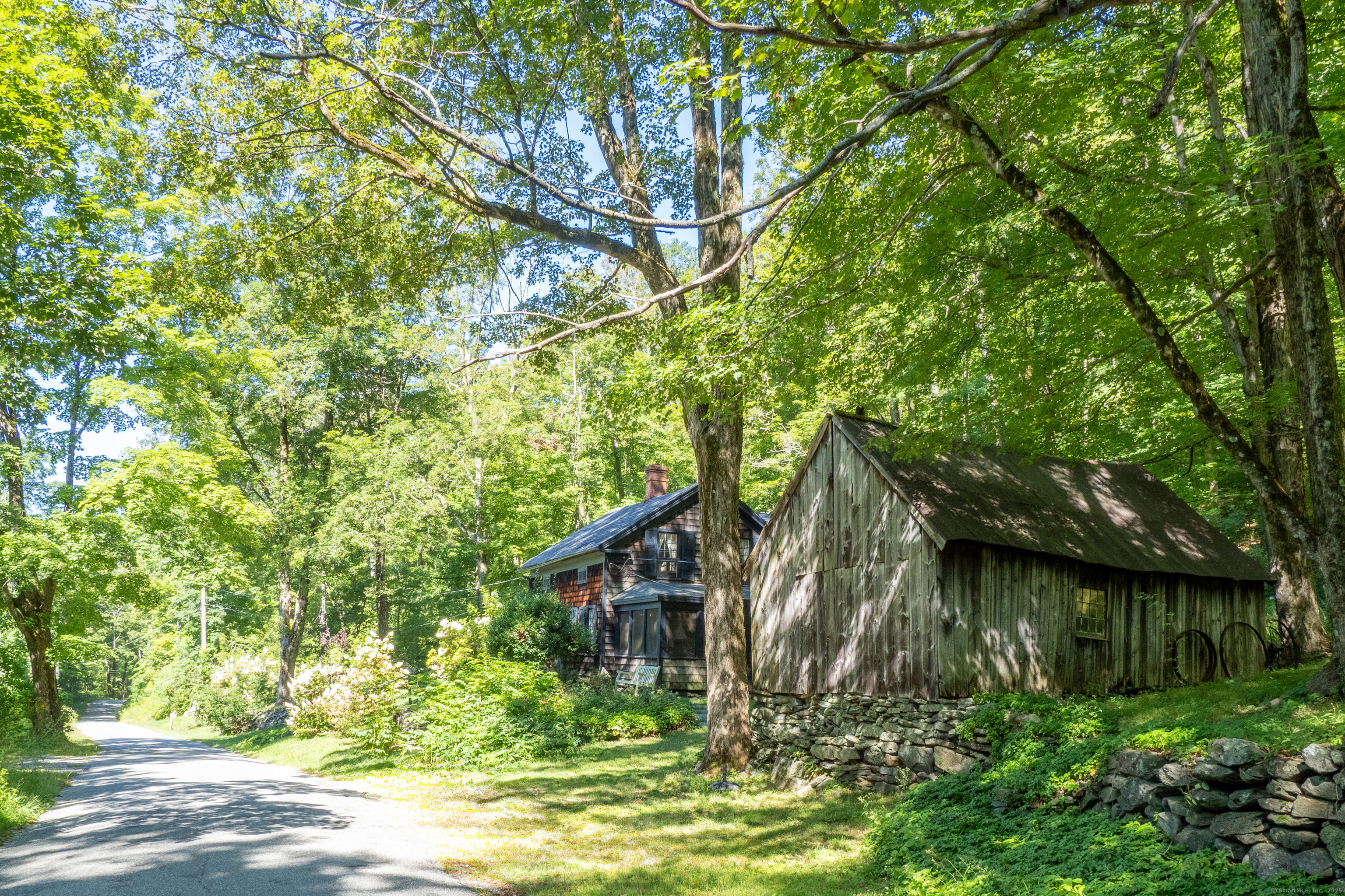 143 Whitcomb Hill Road Cornwall, CT 06754 - Photo 4 of 40 a backyard of a house with lots of green space