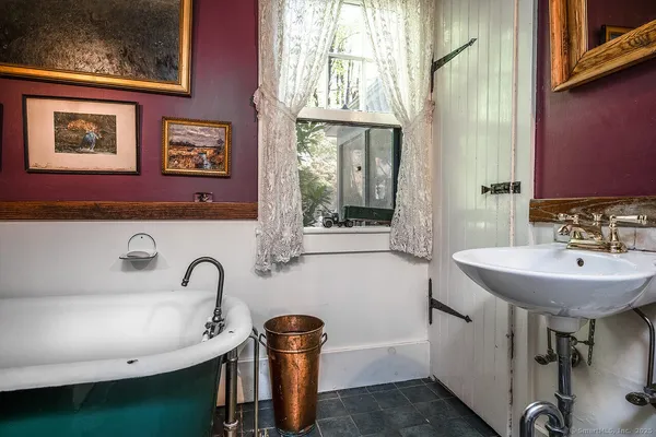 a bathroom with a sink a mirror and a window
