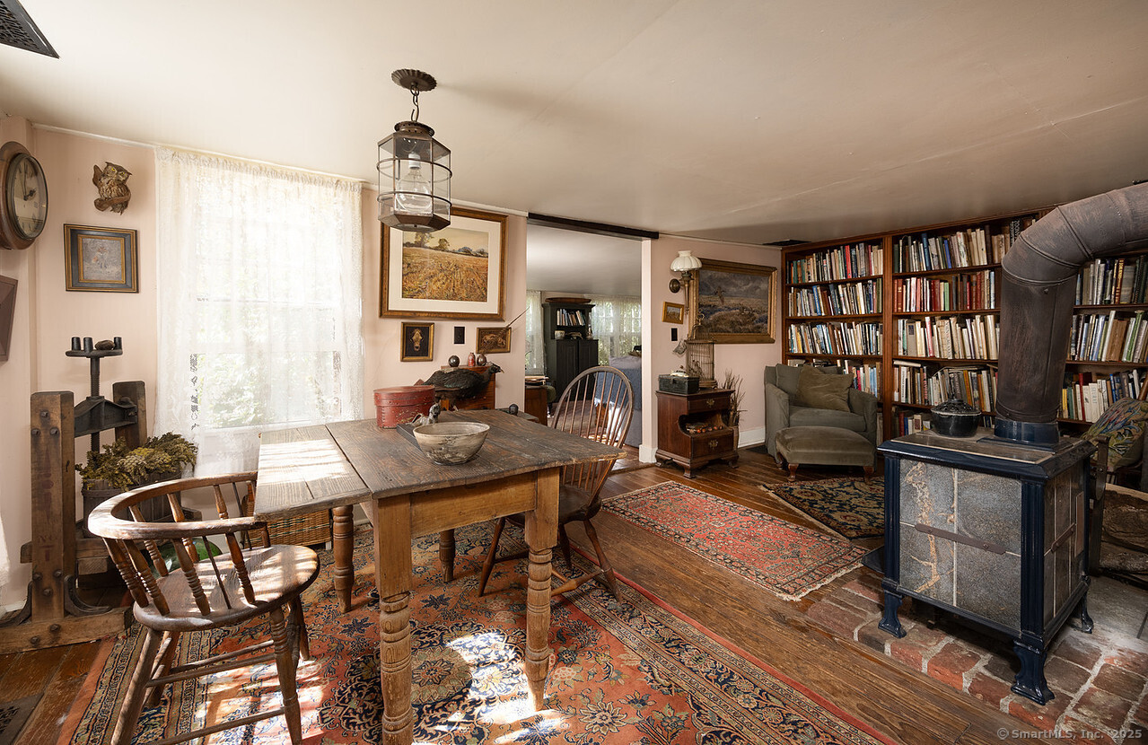 143 Whitcomb Hill Road Cornwall, CT 06754 - Photo 9 of 40 a living room with furniture a bookshelf and appliances