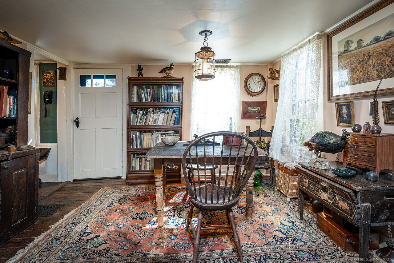 143 Whitcomb Hill Road Cornwall, CT 06754 - Photo 10 of 40 a living room with furniture a bookshelf and a window
