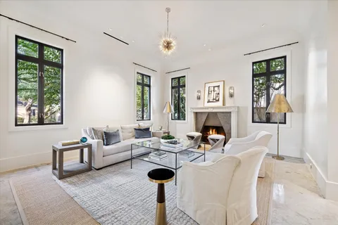 a living room with furniture a window and a fireplace
