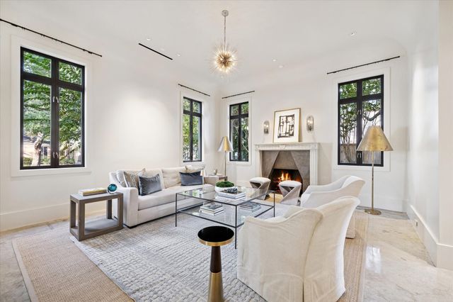 a living room with furniture a window and a fireplace