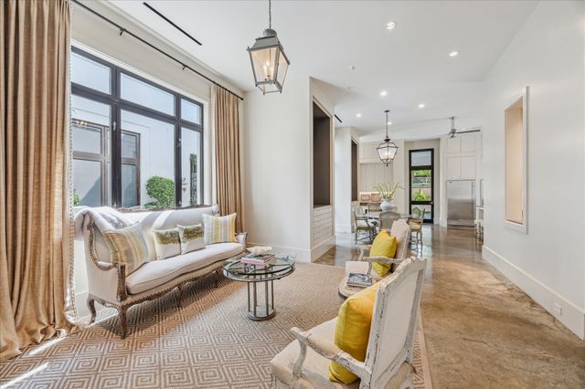 a living room with furniture and floor to ceiling windows