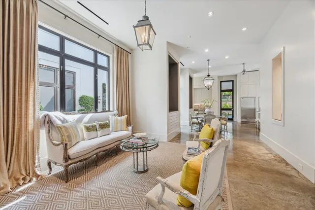 a kitchen with stainless steel appliances a table chairs and a refrigerator
