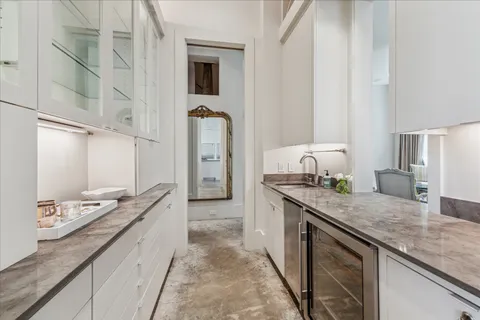 a large kitchen with granite countertop a sink and a stove