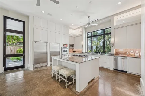 a kitchen with a stove a refrigerator and a stove top oven