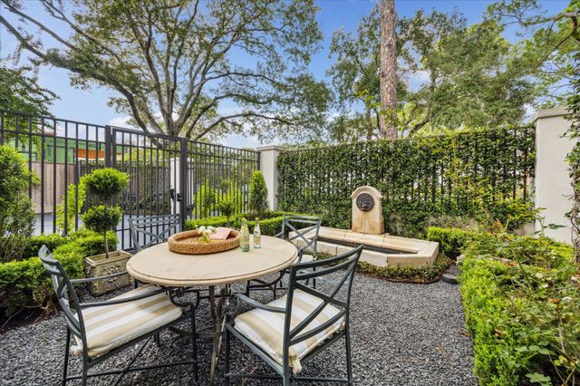 a view of a backyard with furniture and garden
