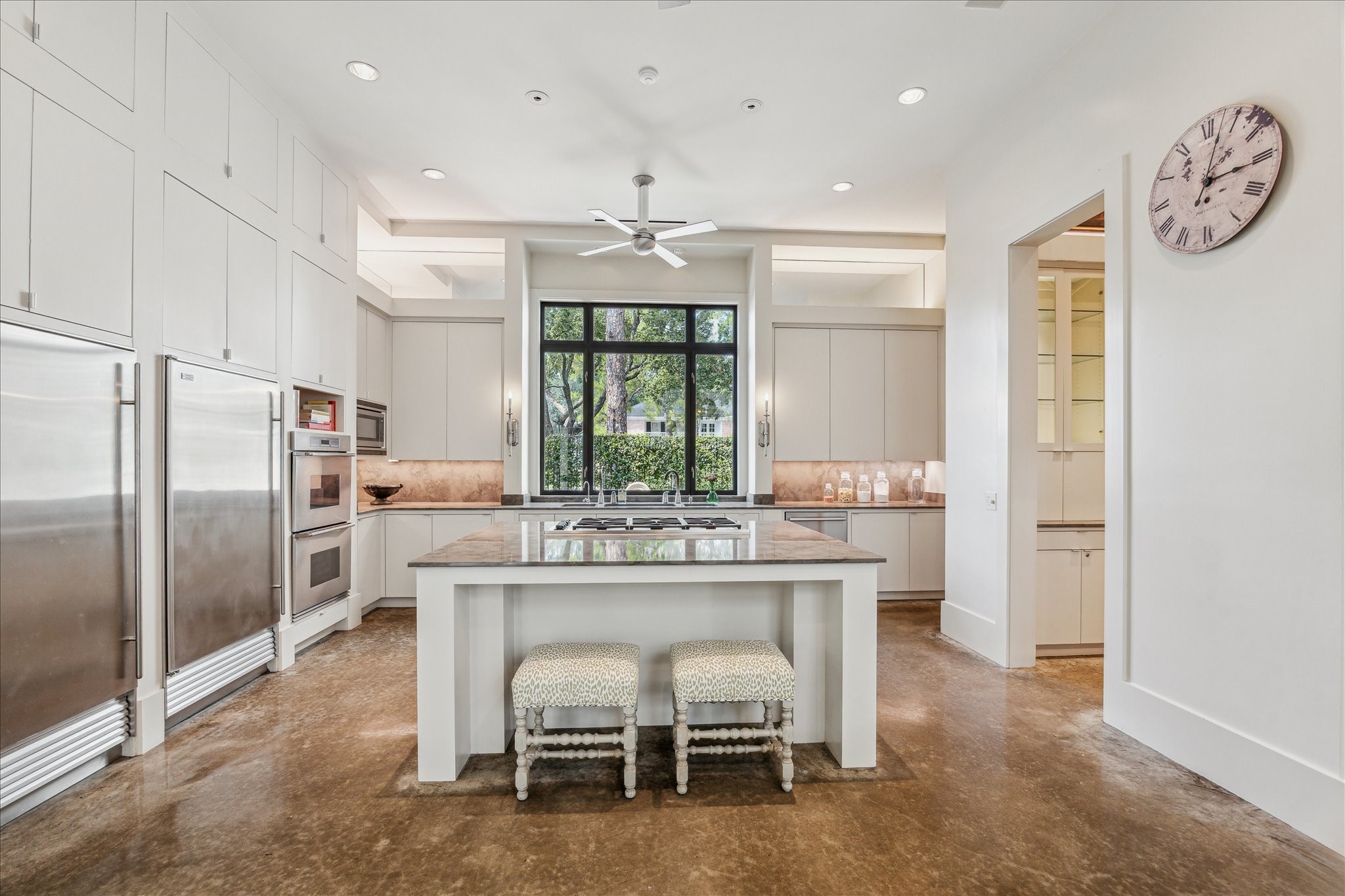 6107 Crab Orchard Road Houston, TX 77057 - Photo 19 of 42 a kitchen with stainless steel appliances a table chairs and a refrigerator