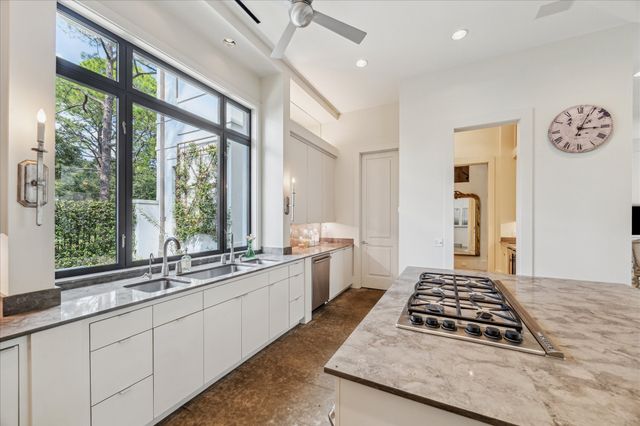 a kitchen with a stove a sink and a window