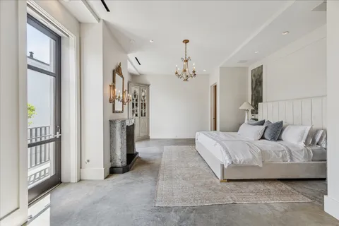 a bedroom with a bed and a chandelier