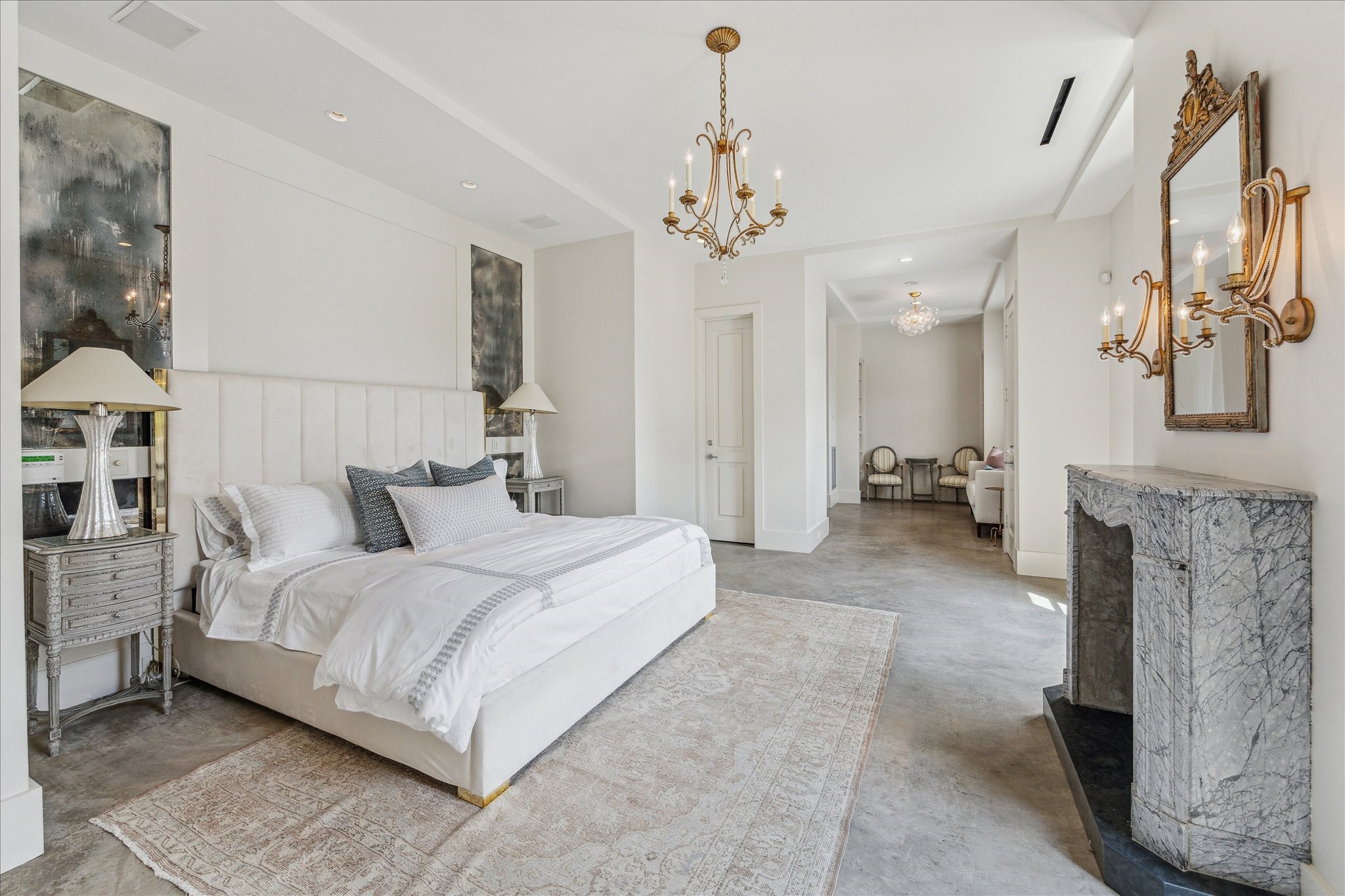 6107 Crab Orchard Road Houston, TX 77057 - Photo 24 of 42 a large bedroom with a bed and a chandelier