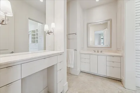 a bathroom with a sink vanity and mirror
