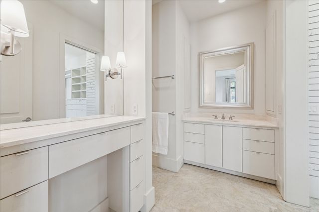 a bathroom with a sink vanity and mirror