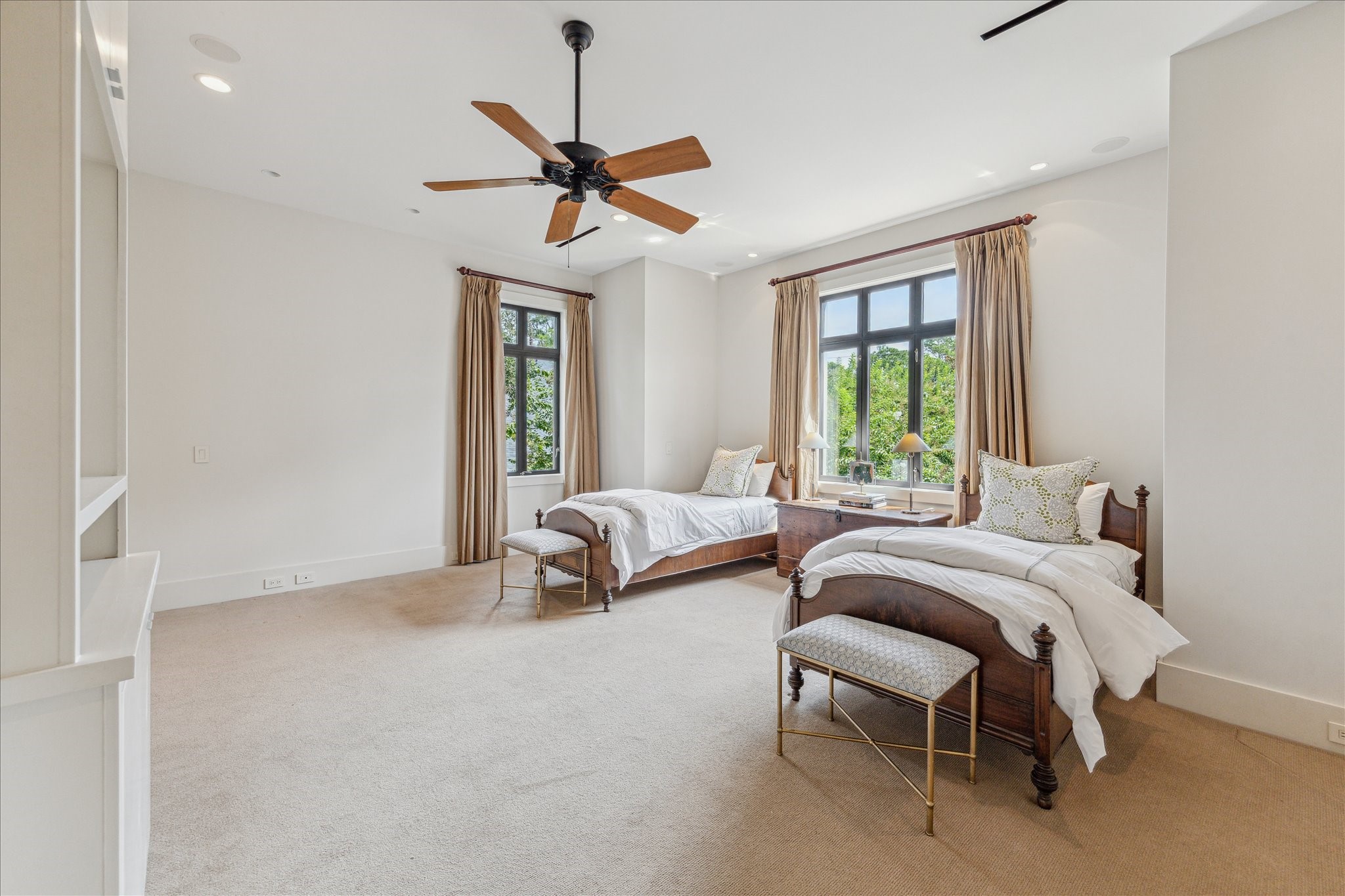 6107 Crab Orchard Road Houston, TX 77057 - Photo 30 of 42 a bedroom with a bed and a chandelier