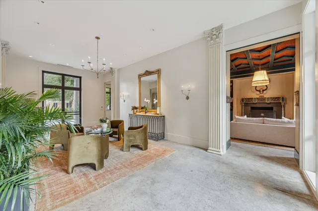 a living room with furniture and a chandelier