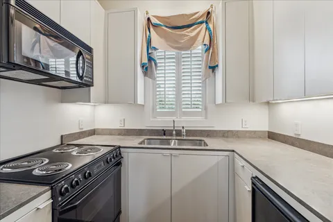 a kitchen with stainless steel appliances granite countertop a sink stove and cabinets