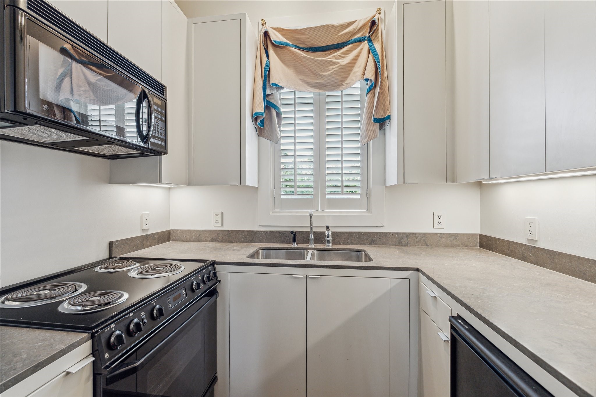 6107 Crab Orchard Road Houston, TX 77057 - Photo 34 of 42 a kitchen with stainless steel appliances granite countertop a sink stove and cabinets