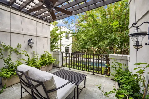 a view of a patio with table and chairs and potted plants