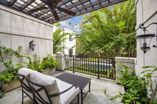 a view of a patio with table and chairs and potted plants
