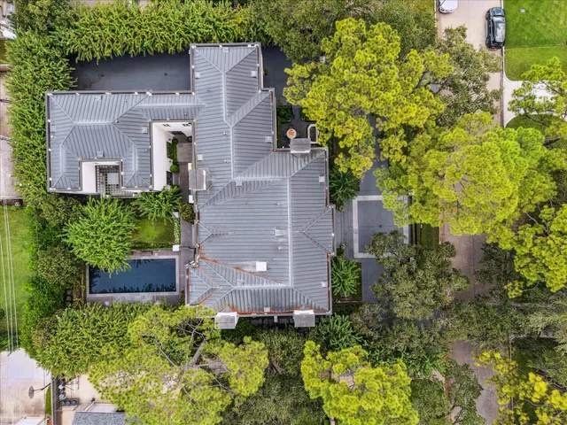 an aerial view of a house with a garden and yard