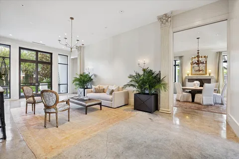 a living room with furniture and a floor to ceiling window