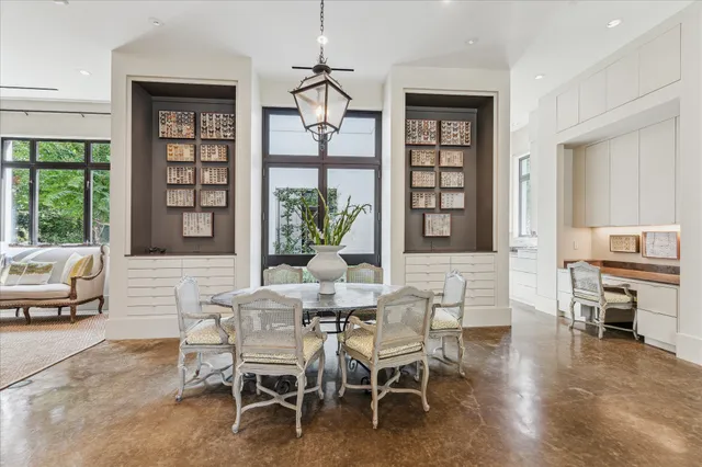 a dining room with a wooden table and chairs