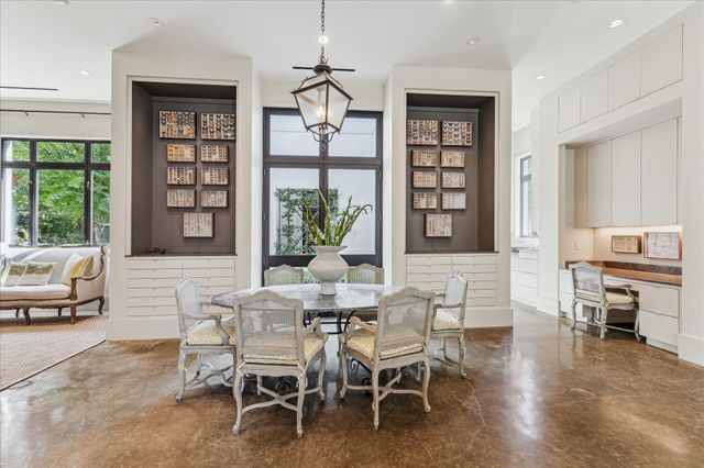 a dining room with a wooden table and chairs