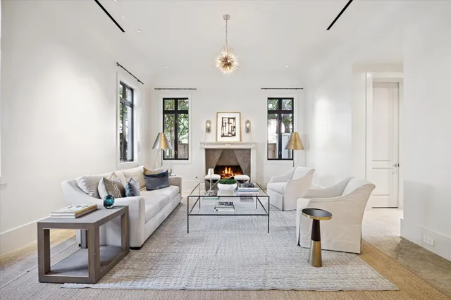 a living room with furniture a fireplace and a large window