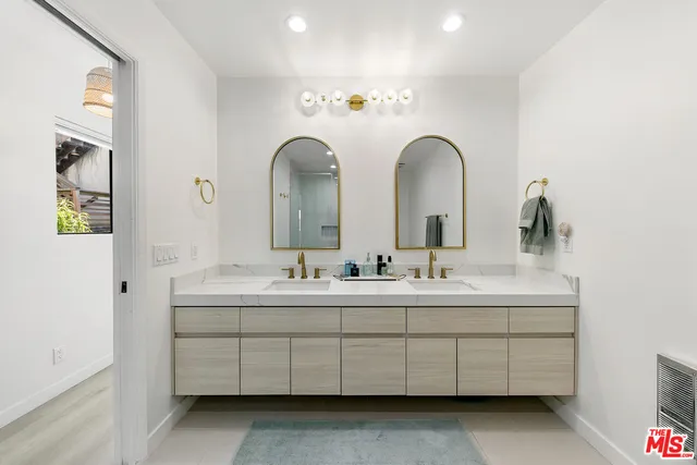 a bathroom with a double vanity sink and a mirror