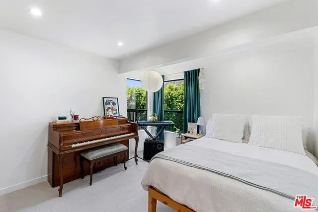 a bedroom with a bed and a piano