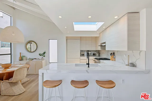 a kitchen with a dining table and chairs