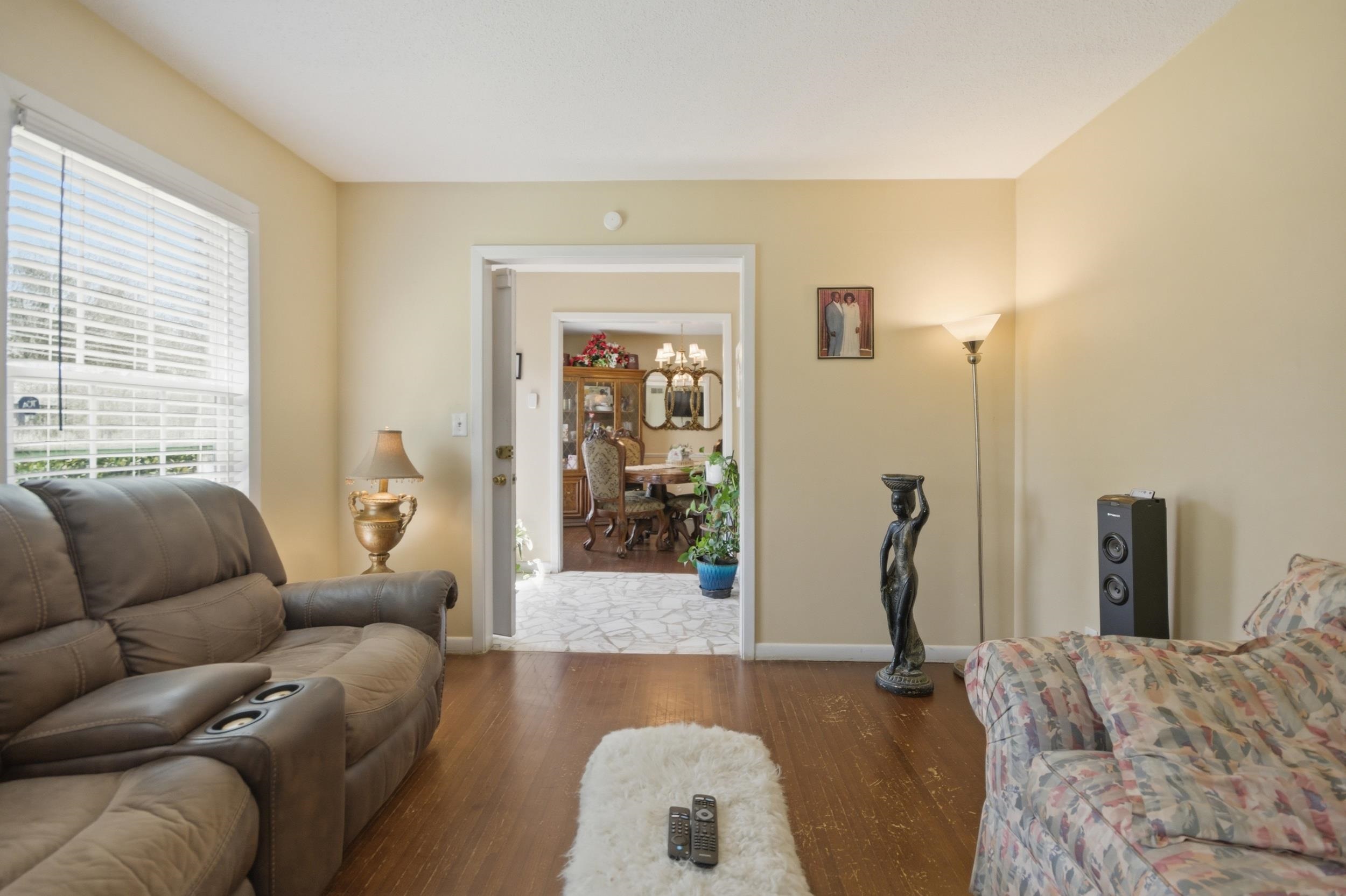 5542 Knight Arnold Road Memphis, TN 38115 - Photo 4 of 17 Living room with wood finished floors and hanging lights