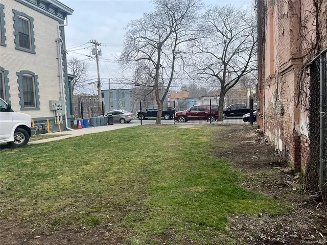a view of a house with a yard and sitting area