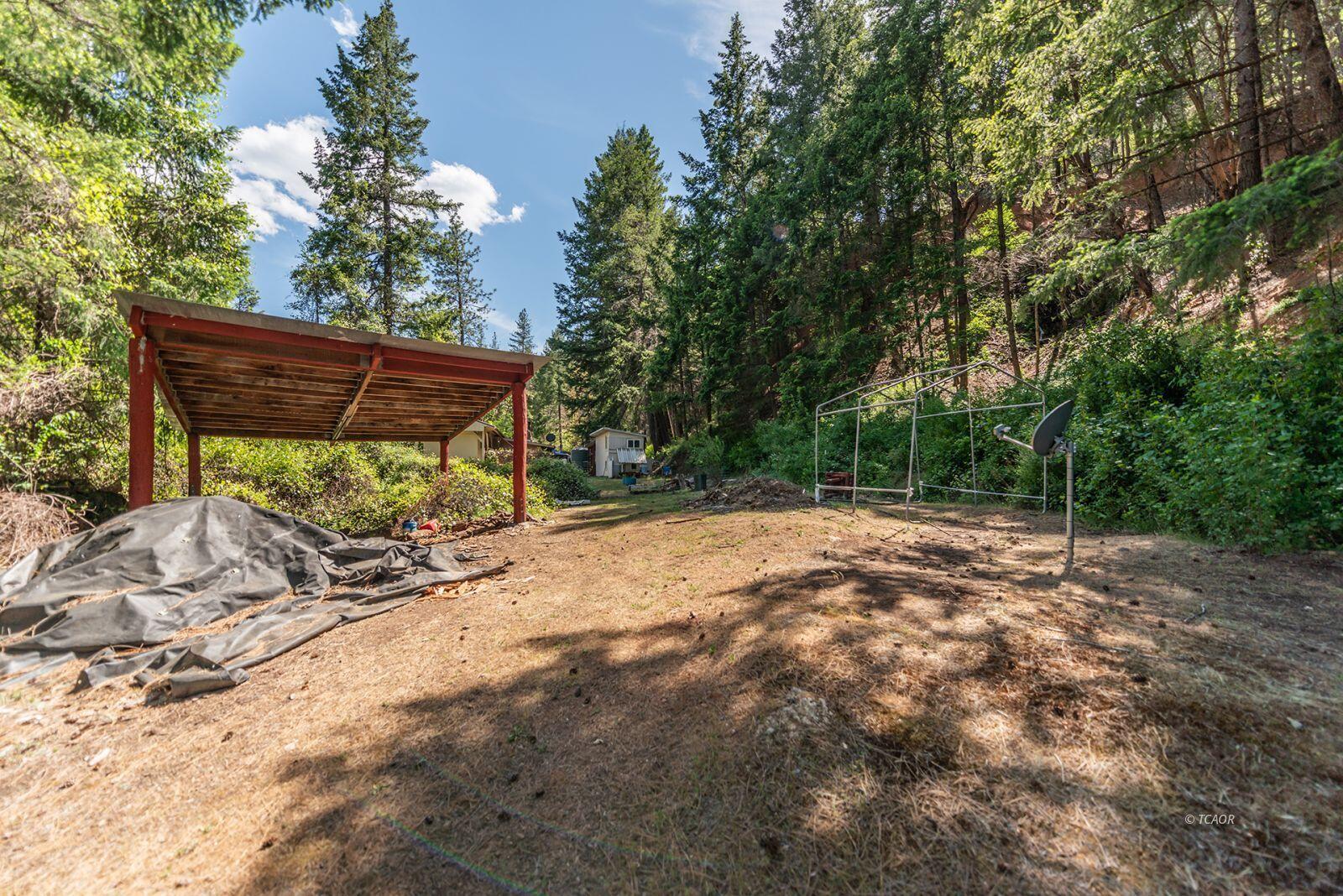 2940 Dutch Creek Road Junction City, CA 96048 - Photo 38 of 47 a view of backyard with wooden fence and a bench