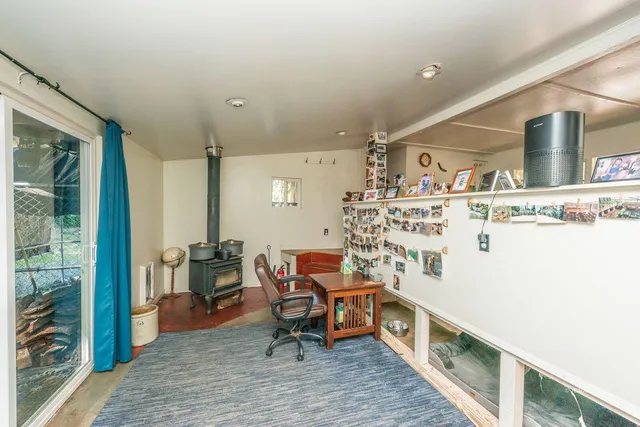 a living room with furniture and a floor to ceiling window